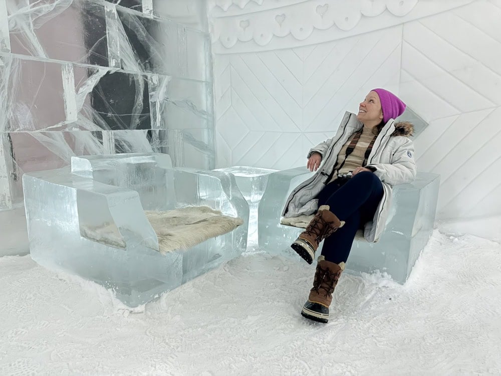 Rachelle sitting on an ice chair in the ice hotel.