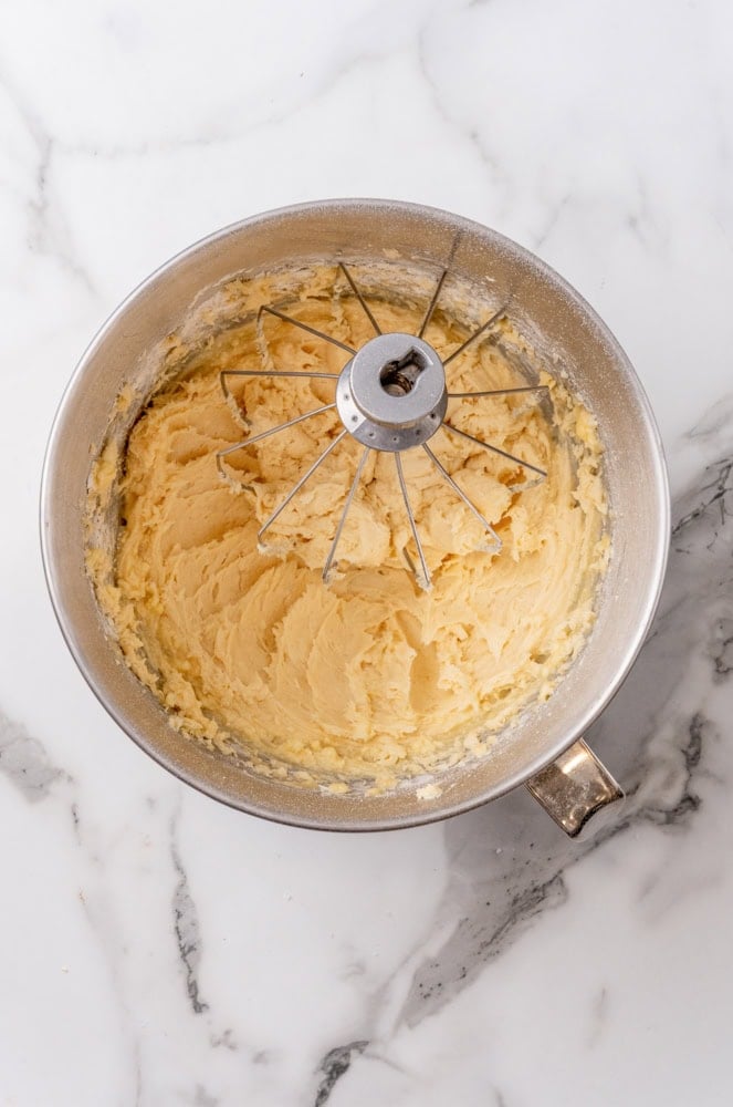 dough mixed together in a mixing bowl with whisk attachment still in bowl
