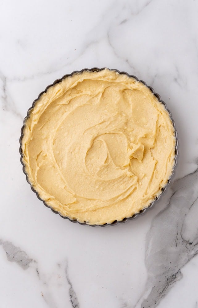 raw dough for almond tart crust in tart pan