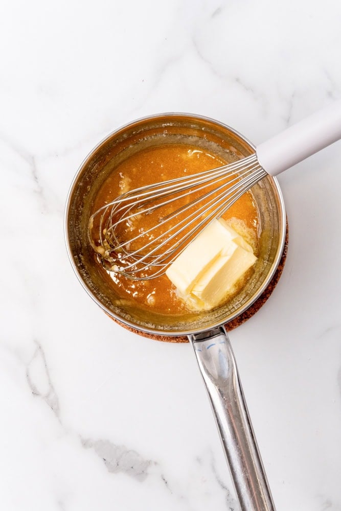 adding butter to melted sugar