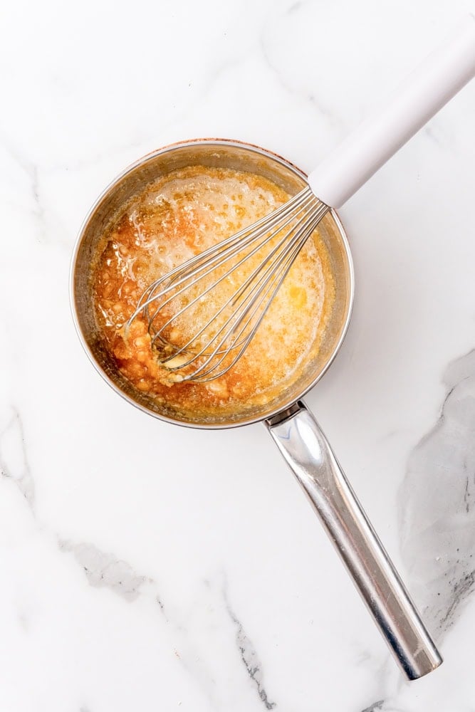 melted butter in caramel in a stainless steel pan