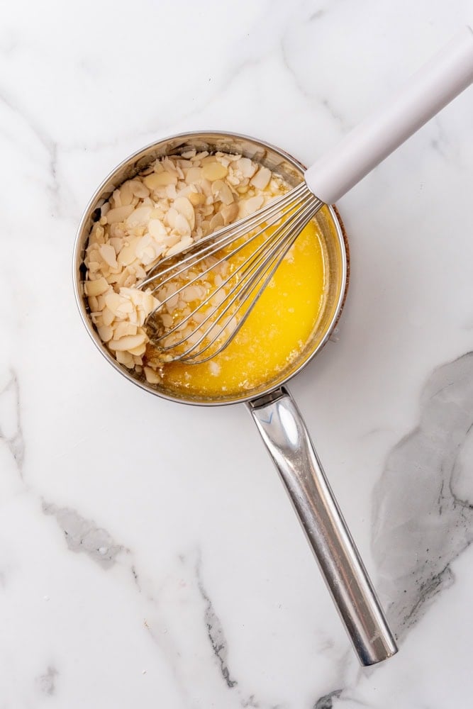 adding slivered almonds to butter and melted sugar