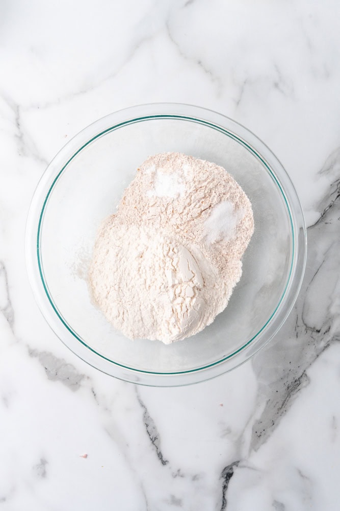 dry ingredients for whole wheat biscuits in glass bowl before mixing