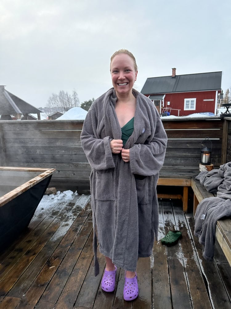 Rachelle in a robe outside the swedish sauna cottage