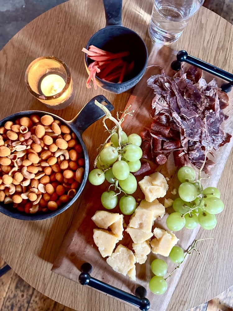 charcuterie plate with grapes, cheese, and dried reindeer