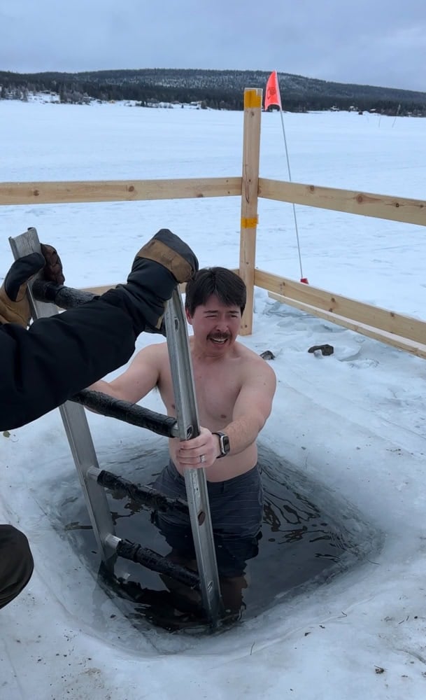 Pete dipping into a frozen river