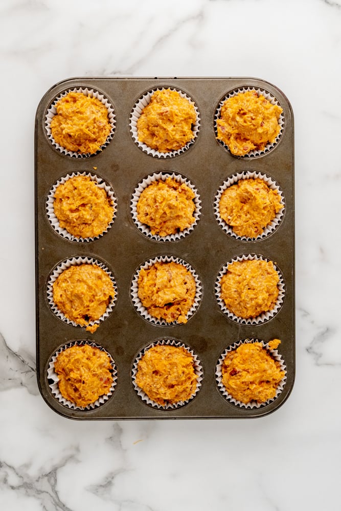 sweet potato muffins in a muffin tin before baking