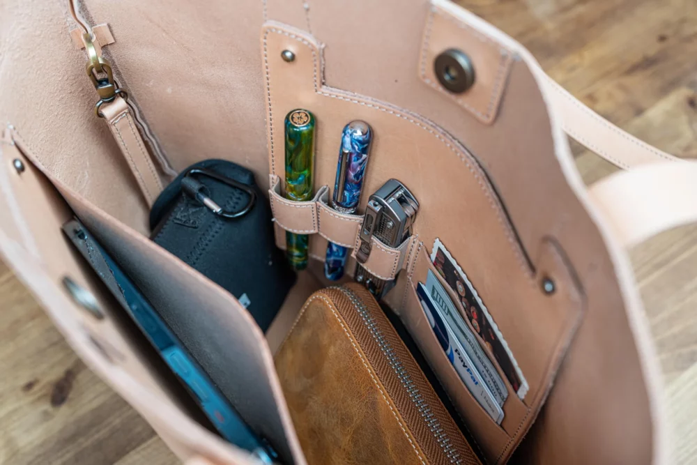 Inside Galen Leather bag showing pen and pocket organization.