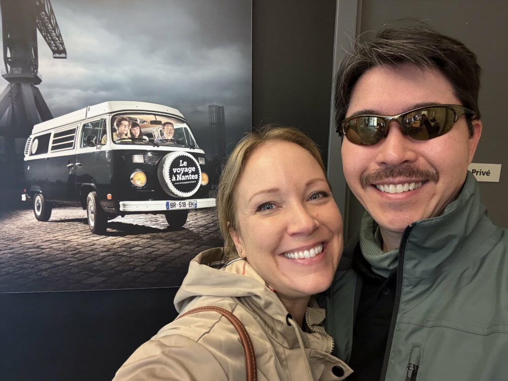 Rachelle and Pete in front of Le Voyage a Nantes bus photo.