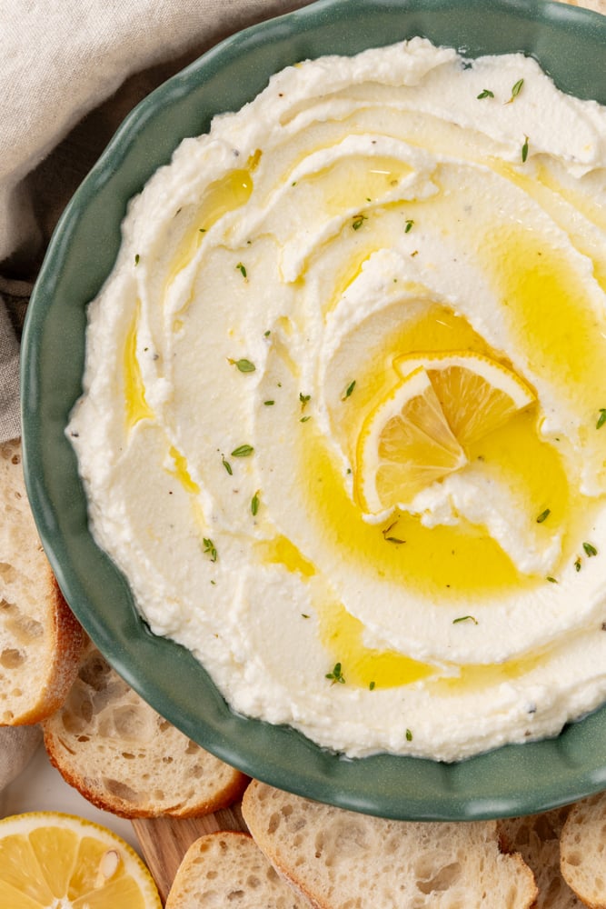 Bowl of whipped ricotta dip with toastettes