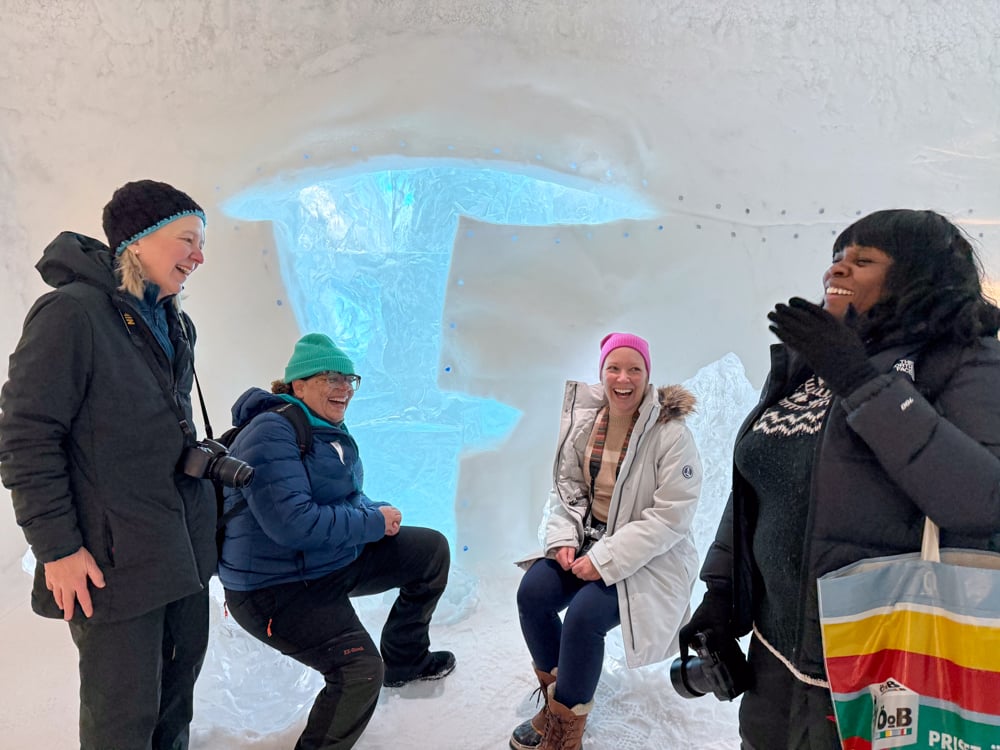Our tour group sitting and laughing in the ice hotel