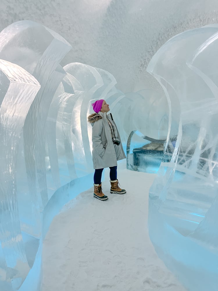 Rachelle looking up at an ice sculpture in the ice hotel.