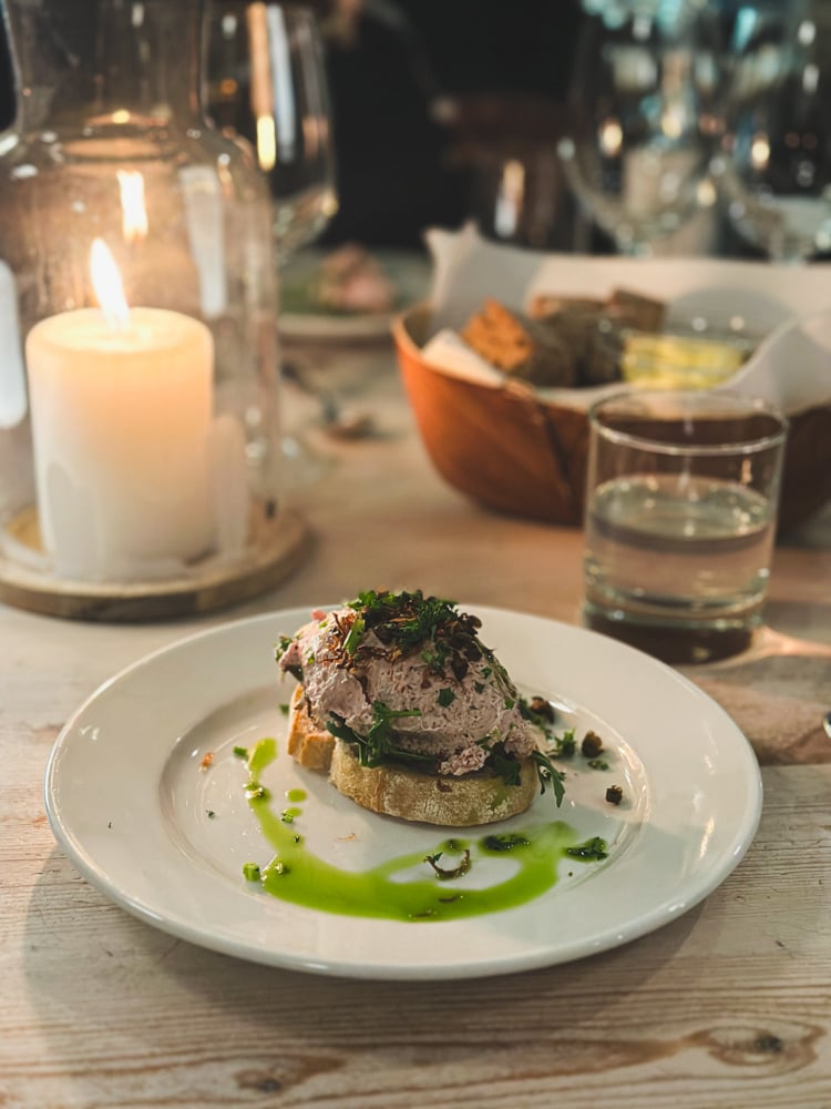 Photo of appetizer and candle on a table at Abisko touristation restaurant.