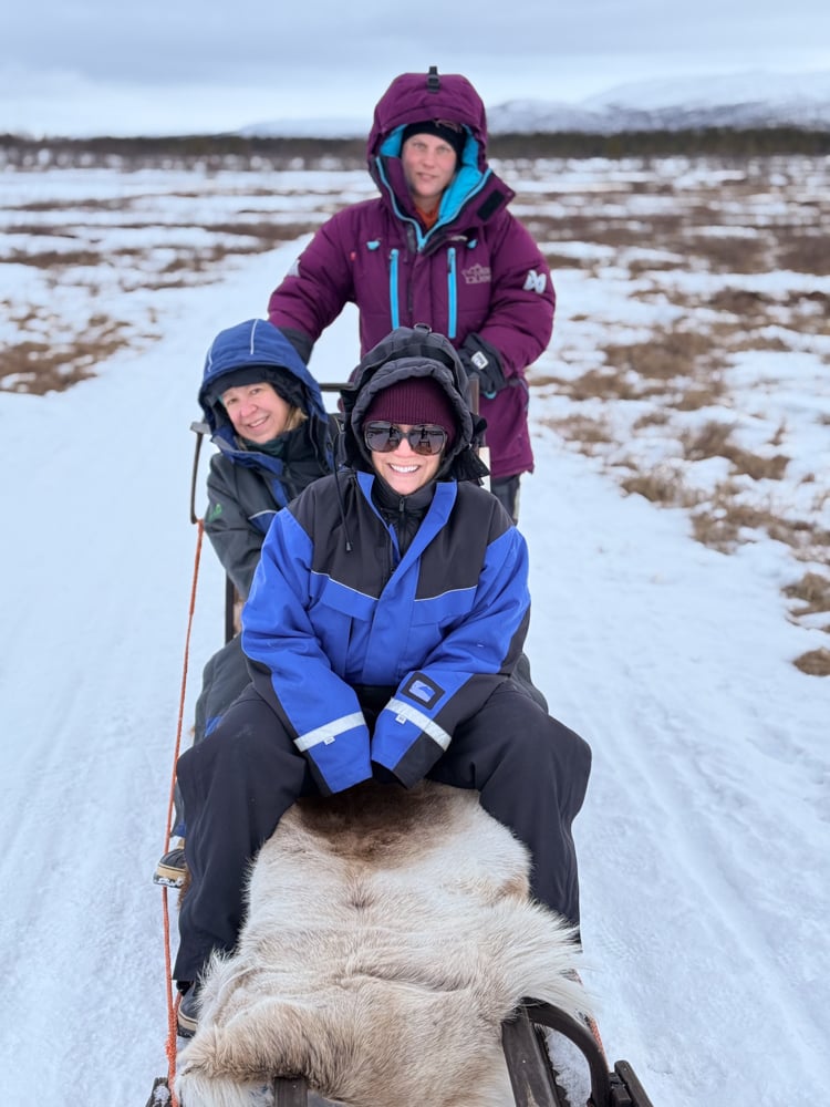 Rachelle with a friend and guide on a sleigh