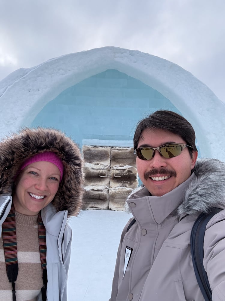 Rachelle and Pete taking a selfie in front of the ice hotel