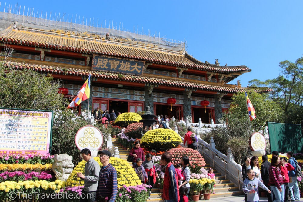 Entrance to building with traditional Chinese architecture and tiled roof.