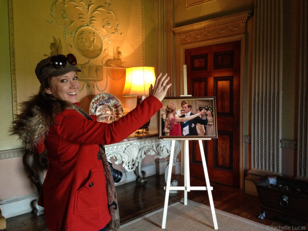 Rachelle in an orange jacket posing like the photo of Lady Edith dancing in Downton Abby