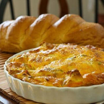 Whole Italian breakfast strata in a white pie pan fresh out of the oven