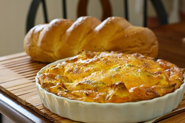 Whole Italian breakfast strata in a white pie pan fresh out of the oven