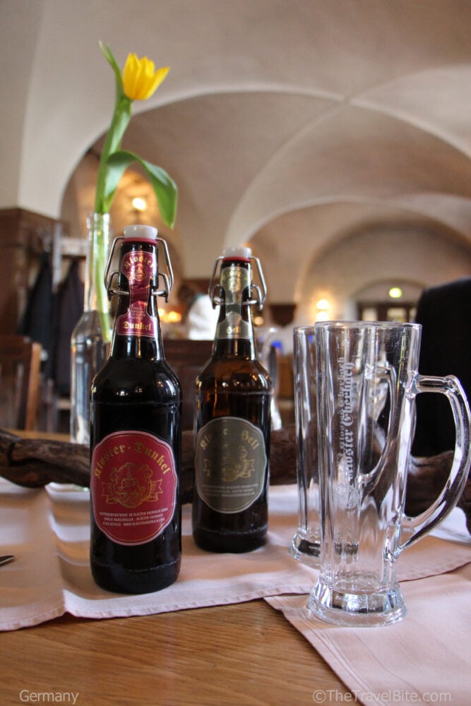 Two bottles of Kloster beer and a empty beer glass