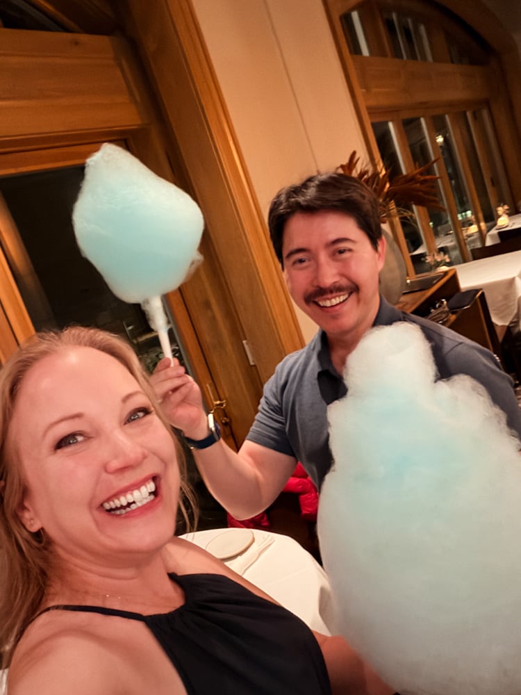 Rachelle and Pete holding up cotton candy at Splendido