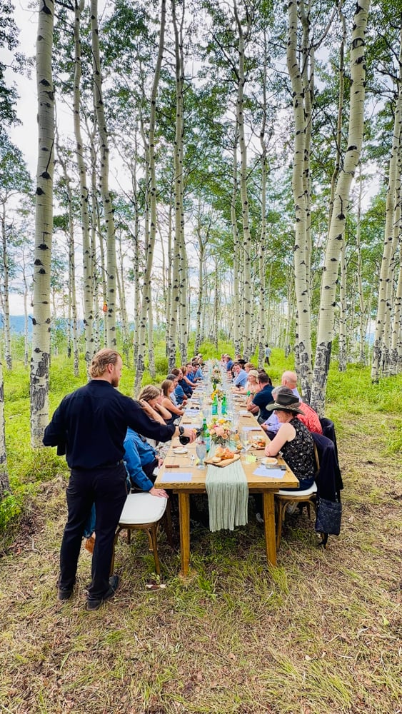 The Alpine Table dinner set among an aspen grove