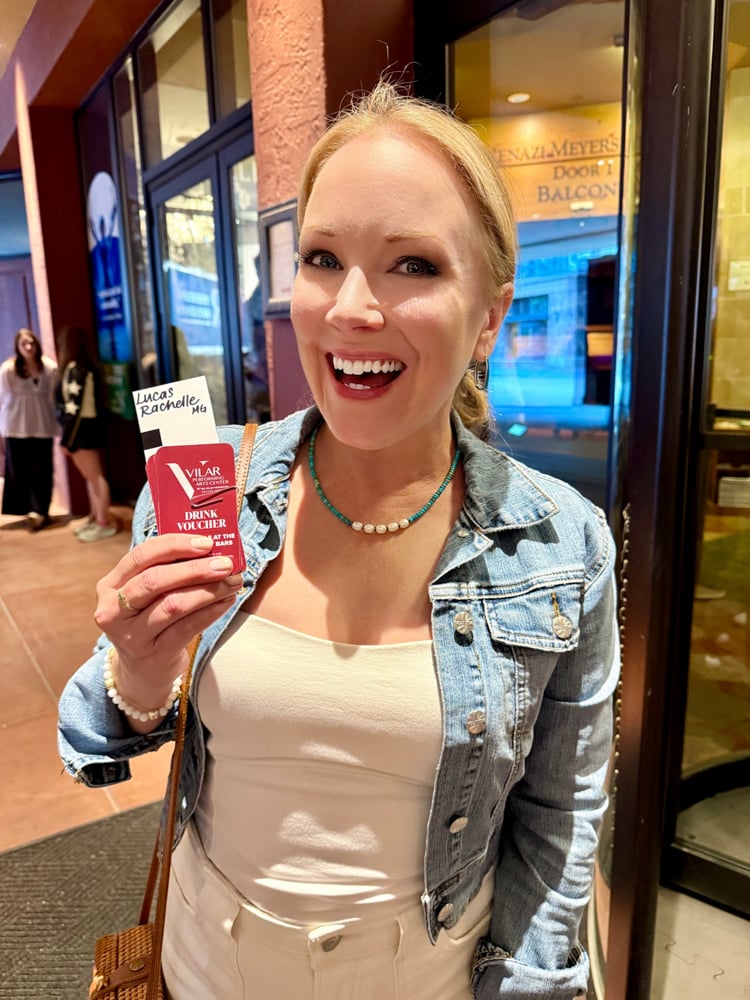 Rachelle holding concert tickets 
