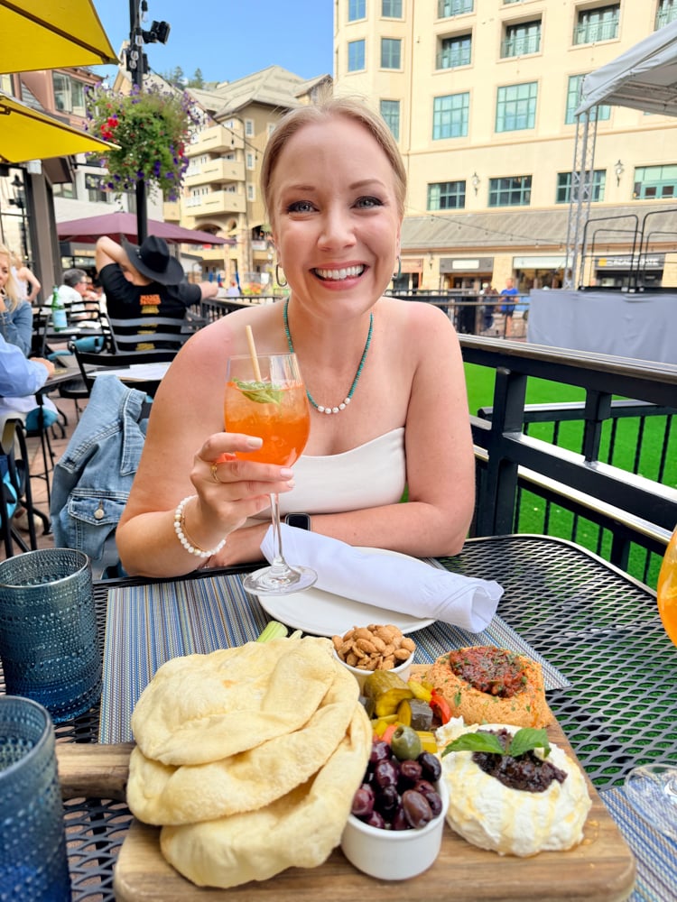 Rachelle holding an orange cocktail at Citrea