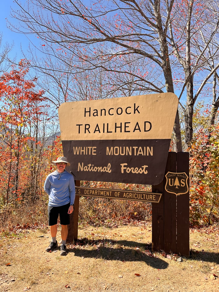 Pete standing in front of th Hancock trailhead white mountain national forest sign