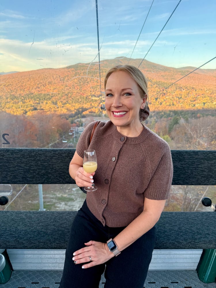 Rachelle holding a glass of juice on the gondola up to Bretton Woods, New Hampshire