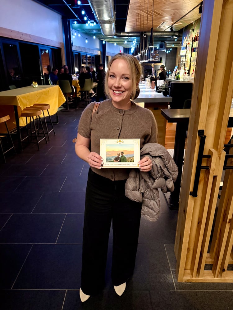 Rachelle holding a printed photograph of her and Pete at the Bretton Woods Full Moon Dinner