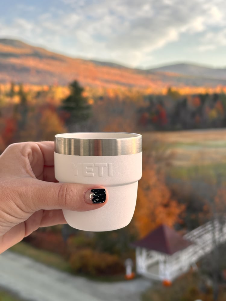 Mini yeti with fall foliage in the background