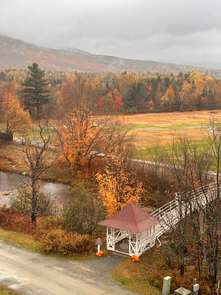 orange fall foliage and covered bridge at the Omni during a New Hampshire fall road trip