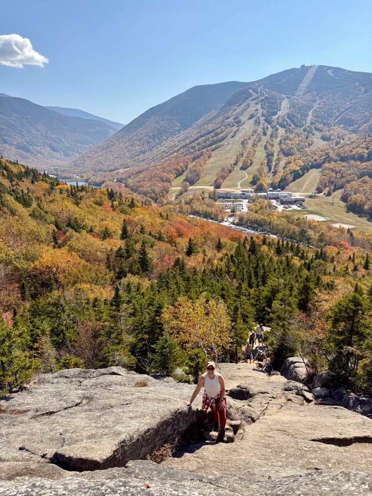 Rachelle scrambling up a boulder at bald mountain