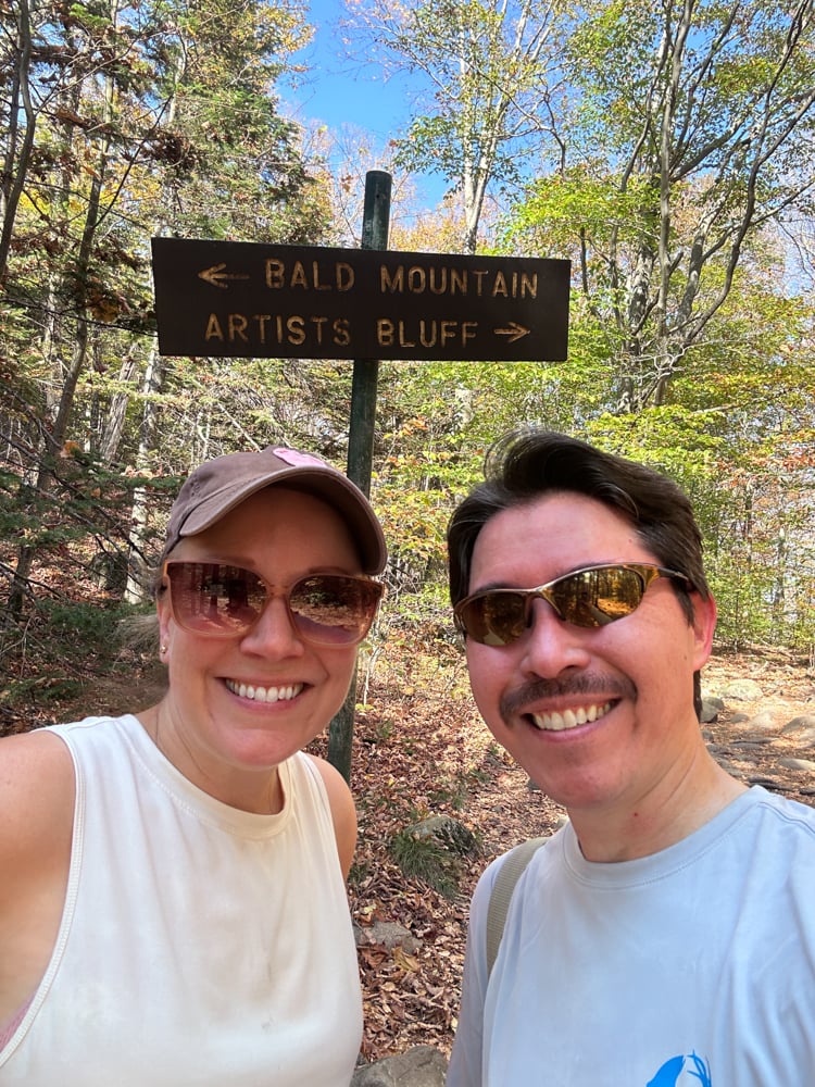 Pete and Rachelle in front of the sign for Bald Mountain