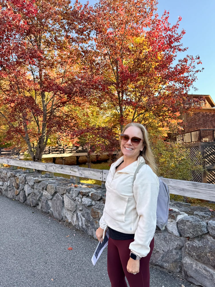Rachelle standing in front of orange and red trees