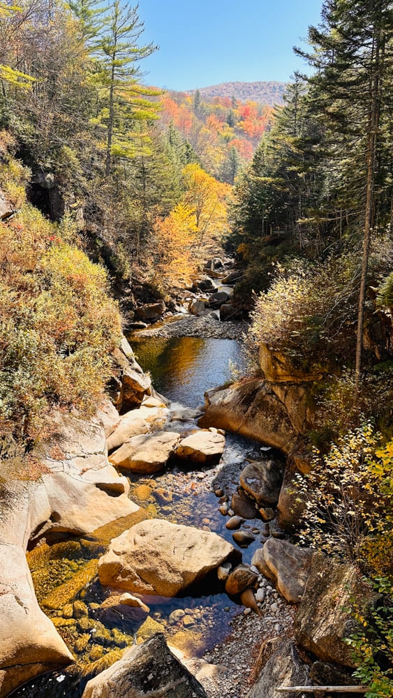 river running through the walking path at the flume