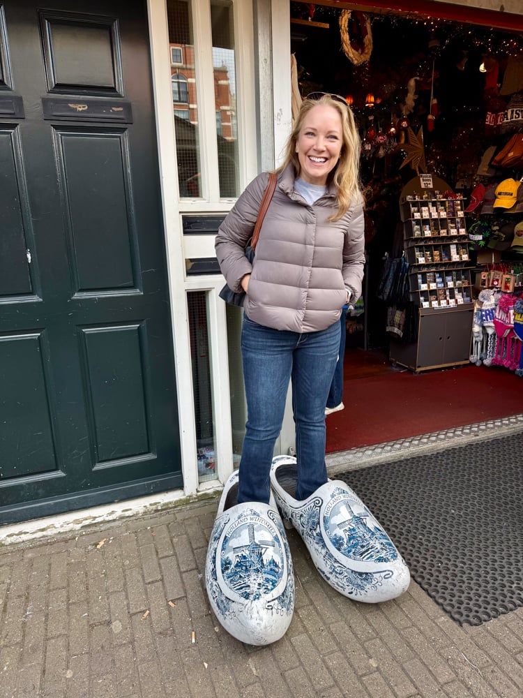 Rachelle stepping inside touristy oversized Dutch shoes for a fun photo