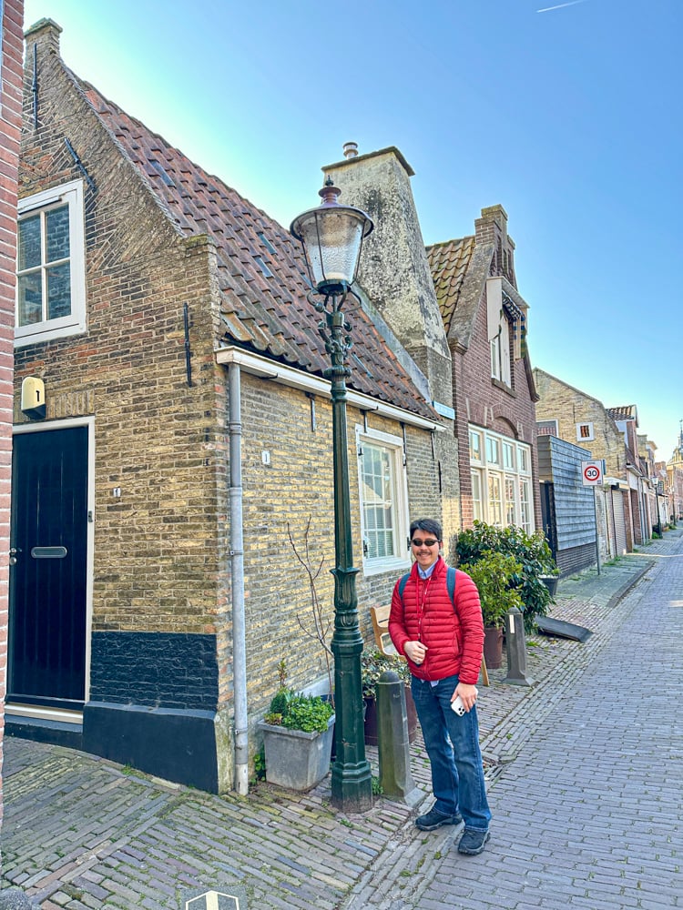 Pete in front of Historic buildings in the fishing village of Enkhuizen