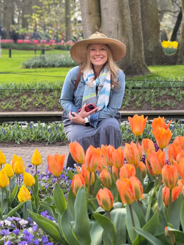 Rachelle in front of colorful tulip beds at Keukenhof Gardens on the Viking Tulips and Windmills river cruise