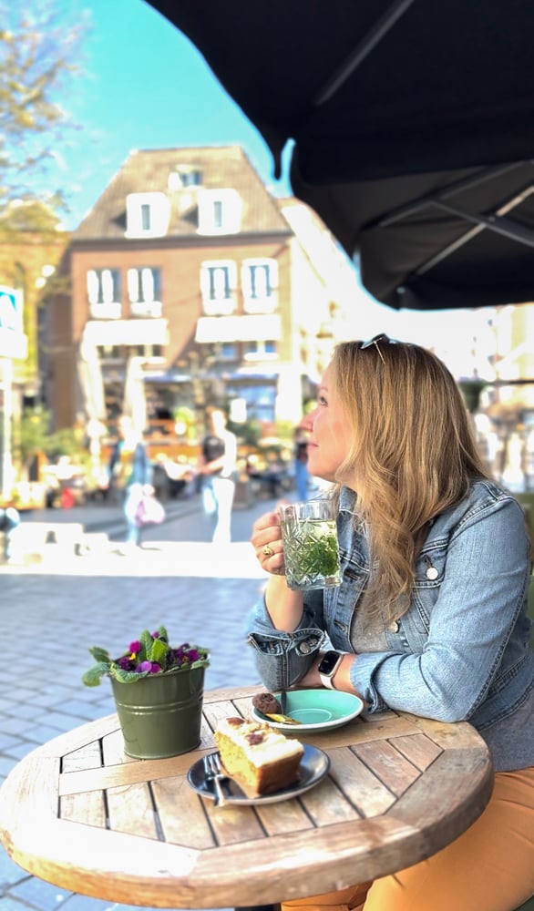 Rachelle enjoying fresh Dutch mint tea and apple cake at a café in Nijmegen