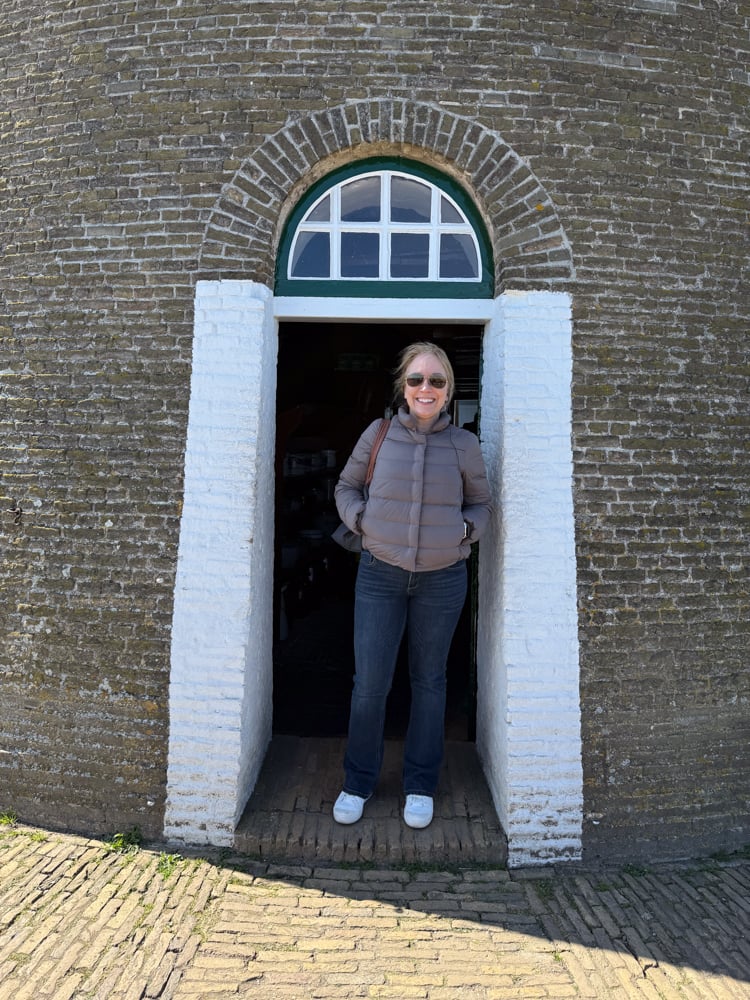Rachelle in the doorway of a windmill at Kinderdijk