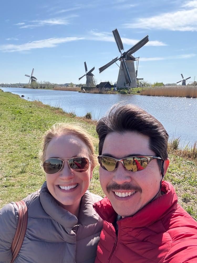 Rachelle and Pete in front of windmills at Kinderdijk